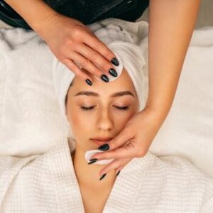 A woman receiving a soothing facial massage at Zen spa for relaxation and skincare.